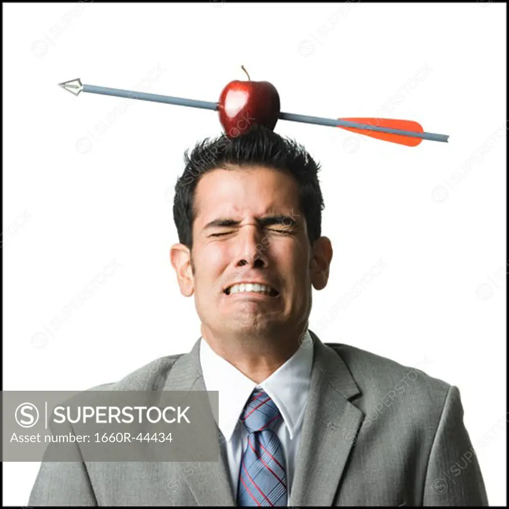 businessman with an apple on his head that has been shot with an arrow