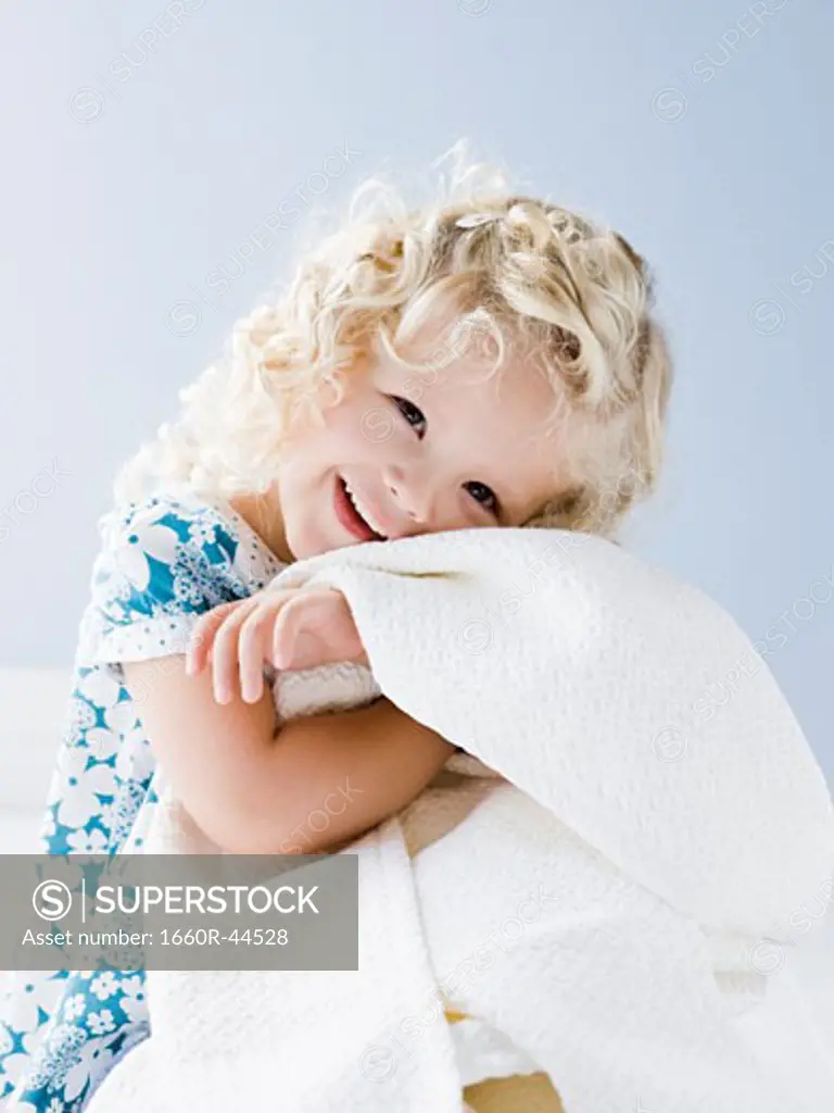 little girl holding her blanket
