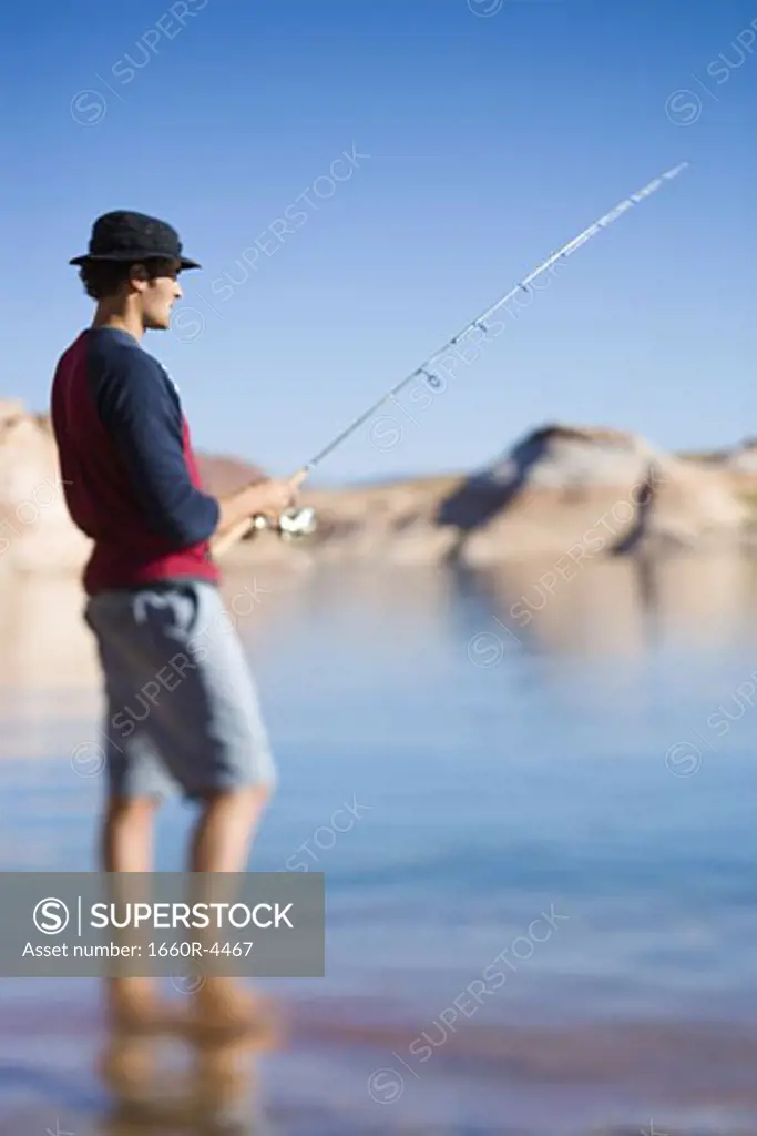 Profile of a young man fishing