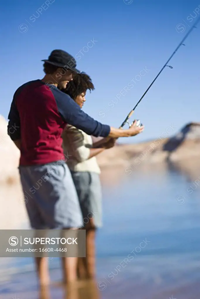 Profile of a young couple fishing