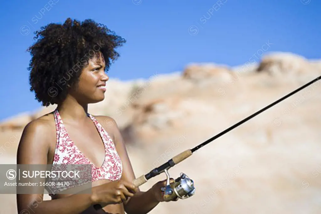 Close-up of a young woman fishing