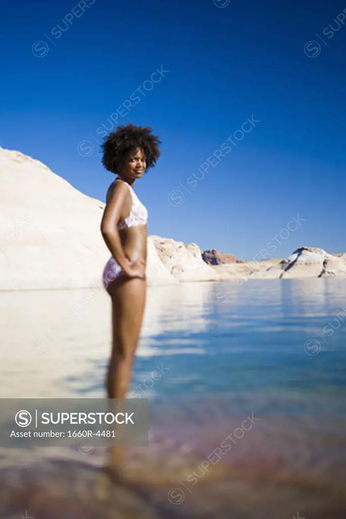 Profile of a young woman standing in water