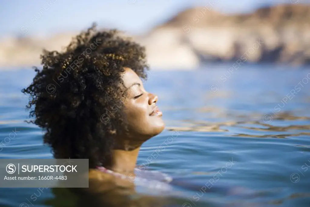 Close-up of a young woman with her eyes closed in water