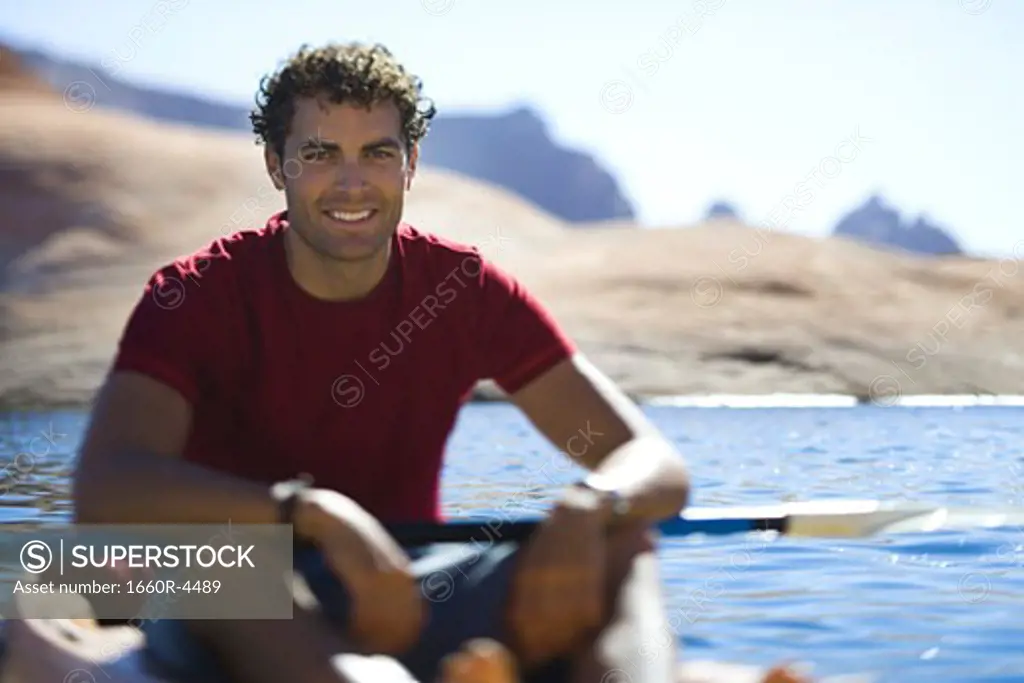 Portrait of a young man sitting in a kayak