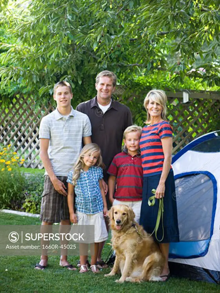 family in the backyard with a tent