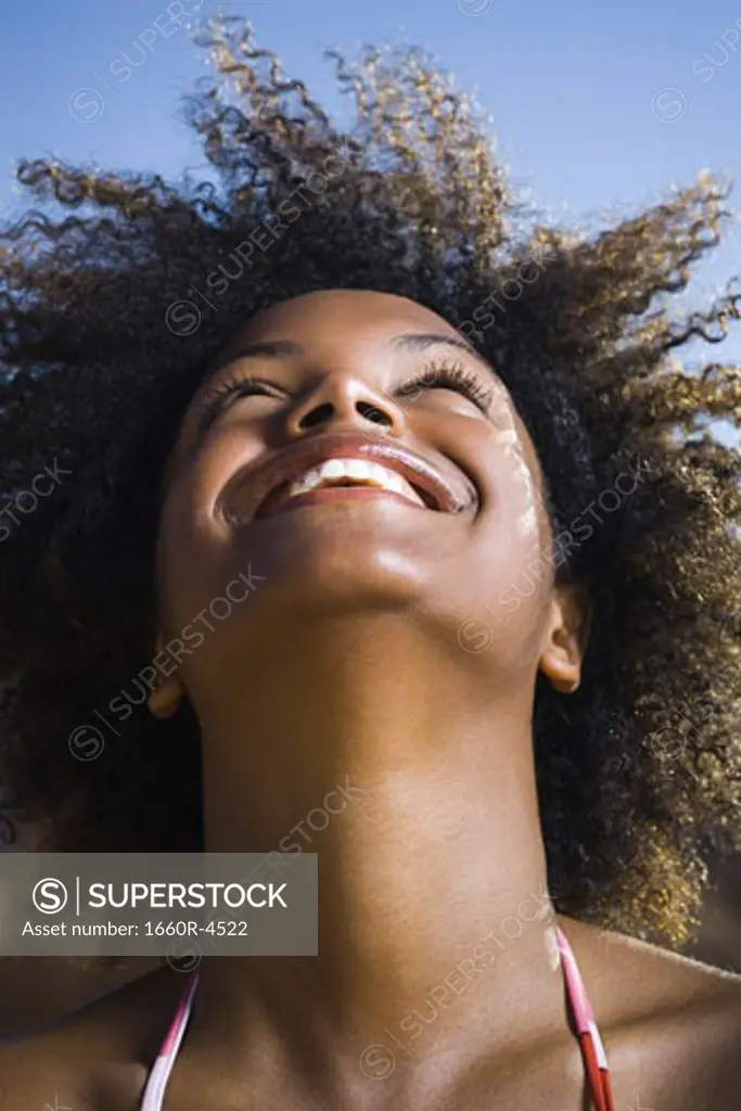 Close-up of a young woman smiling and looking up