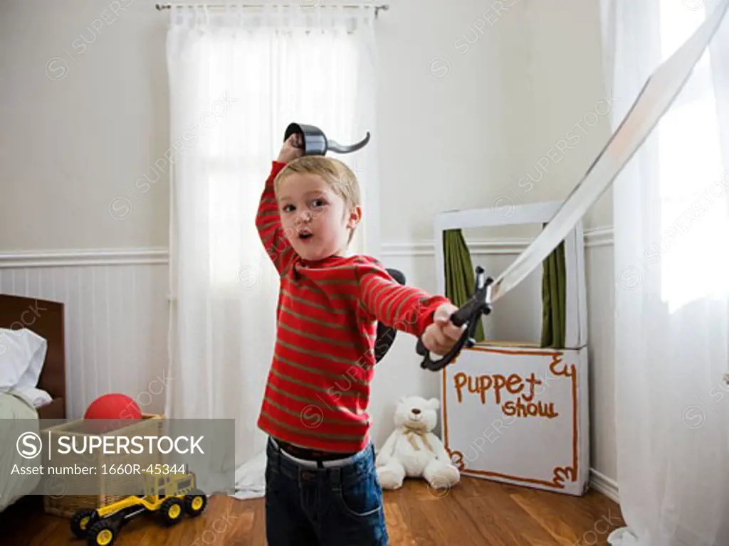 boy pretending to be a pirate in his bedroom