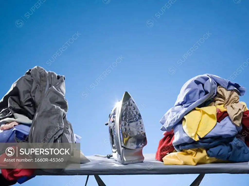 iron next to a pile of clothes