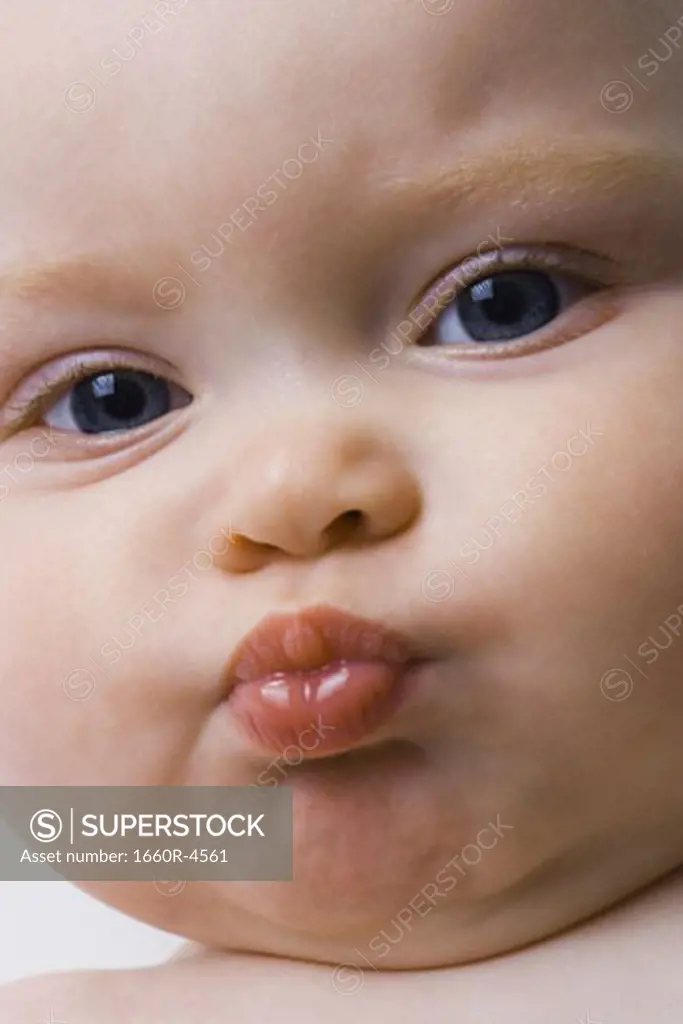Close-up of a baby girl puckering her lips