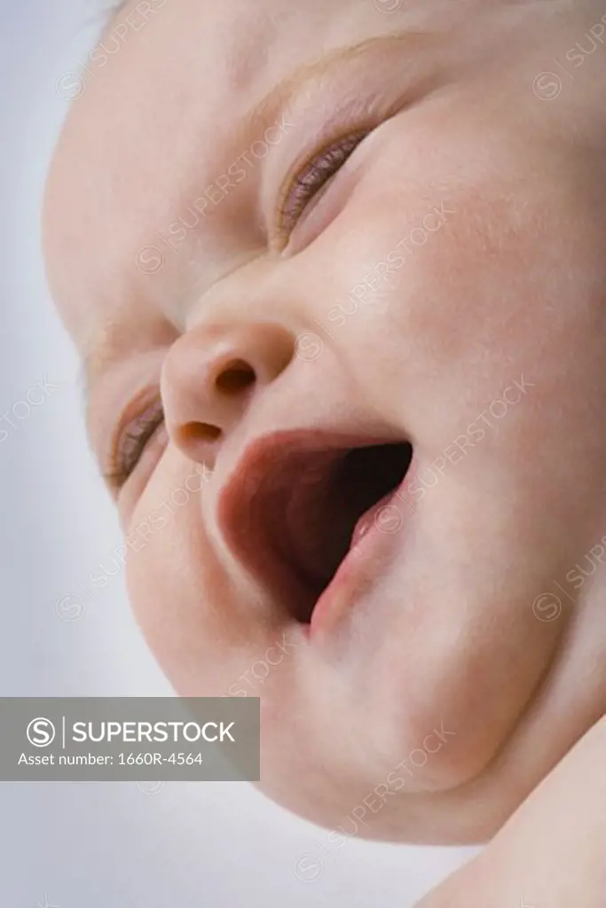 Close-up of a baby girl crying