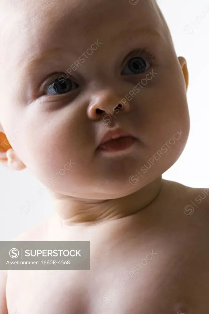 Close-up of a baby girl looking away