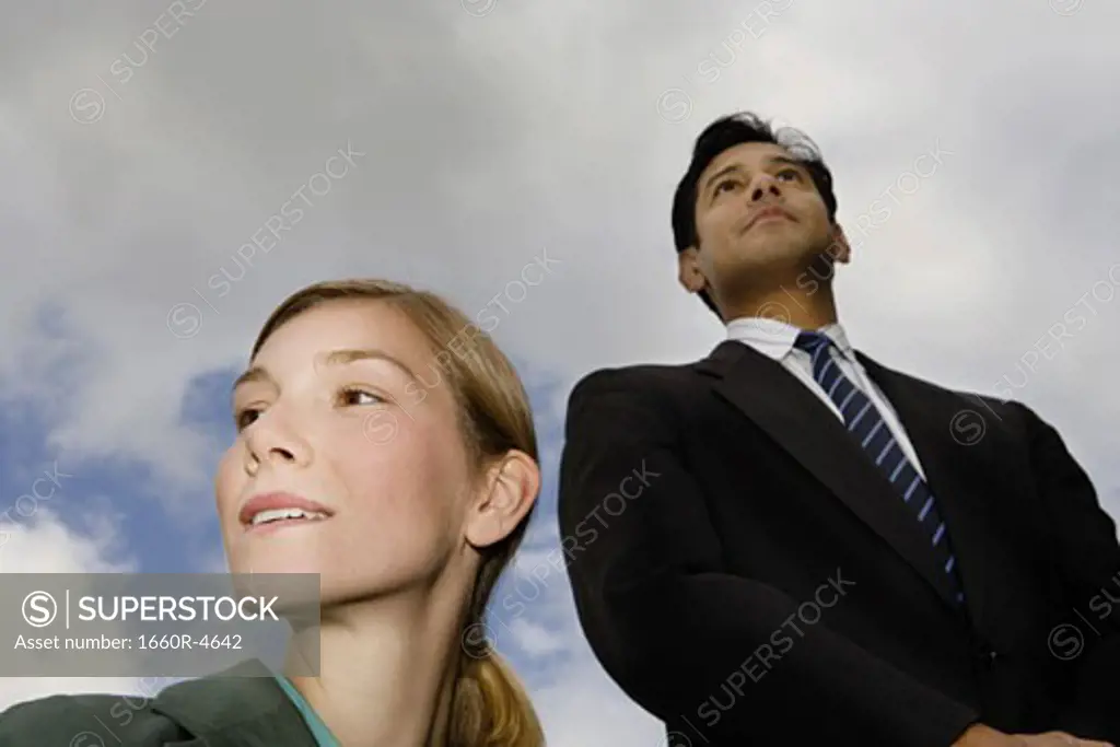 Low angle view of a businessman and a businesswoman standing