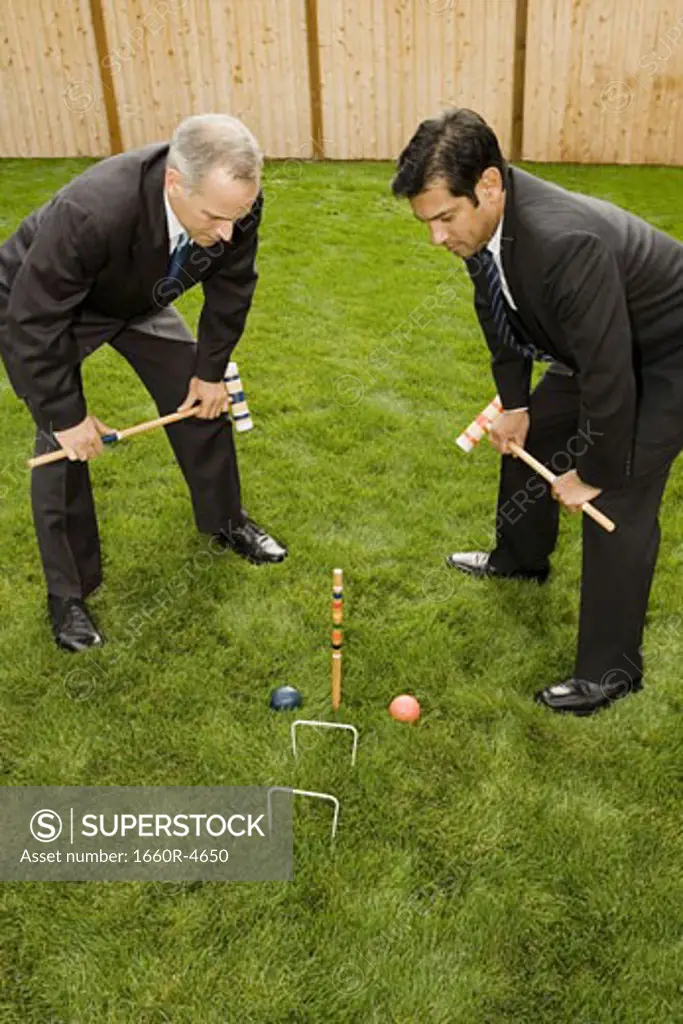 High angle view of two businessmen playing croquet