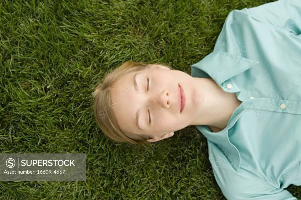 Close-up of a young woman sleeping on grass