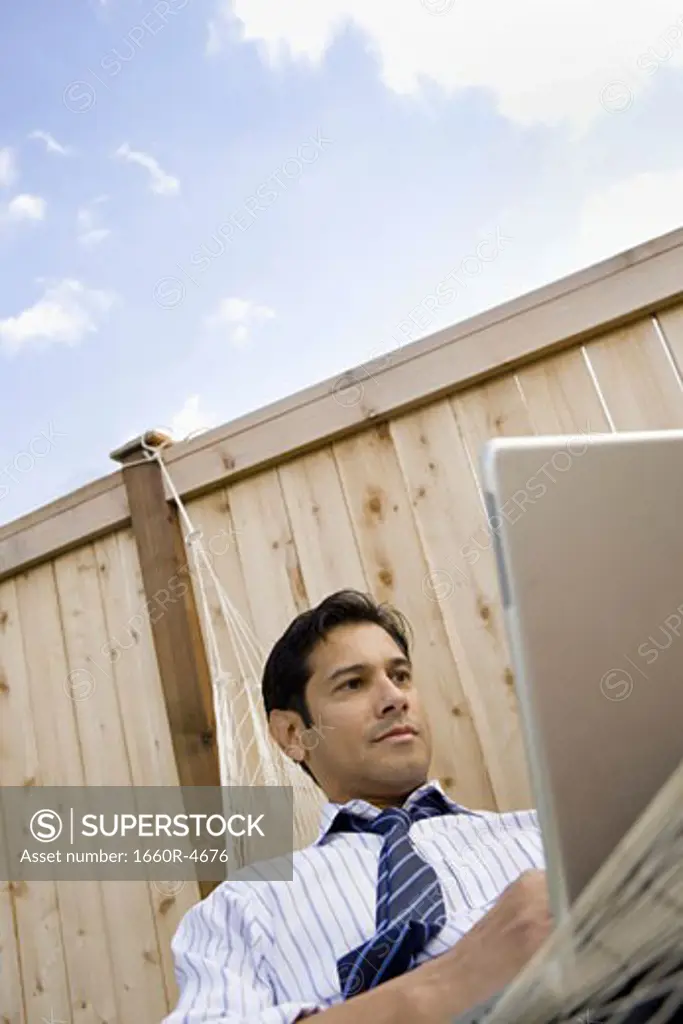 Low angle view of a businessman using a laptop
