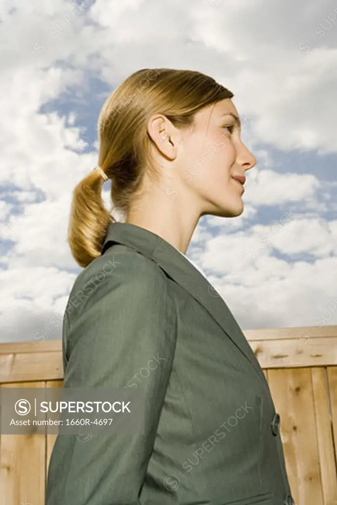 Profile of a young woman standing