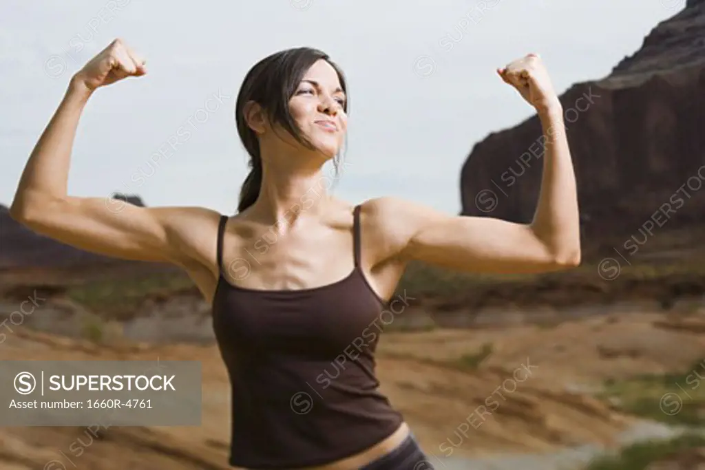 Young woman flexing her muscles