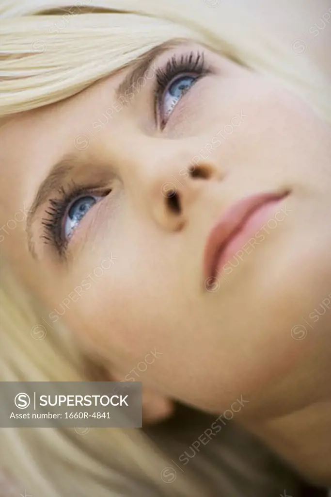 Close-up of a young woman looking up