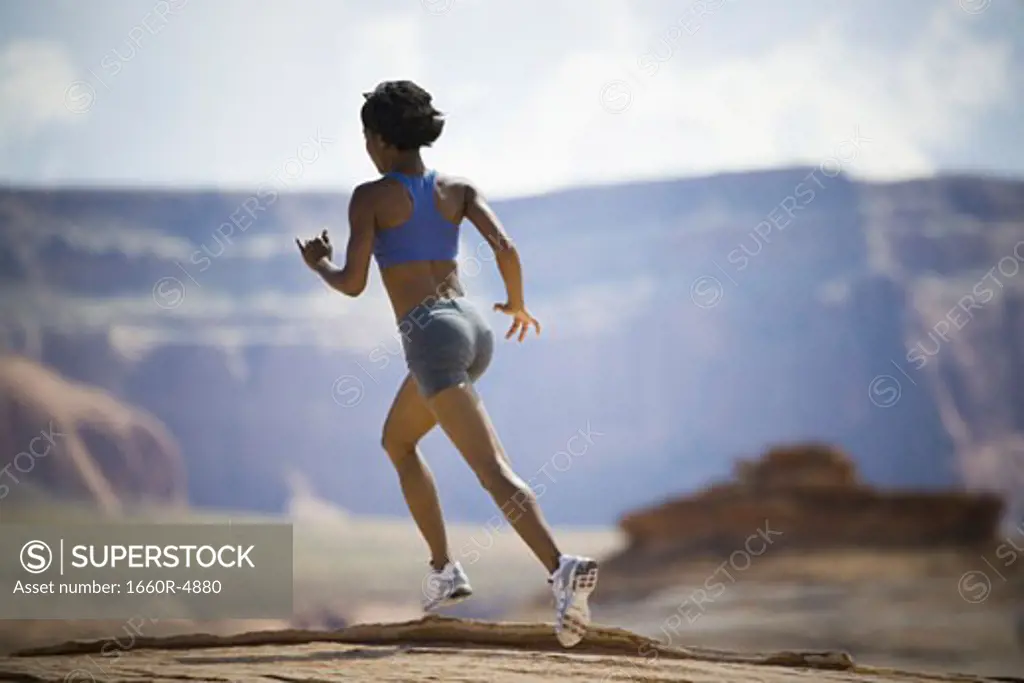 Rear view of a young woman jogging