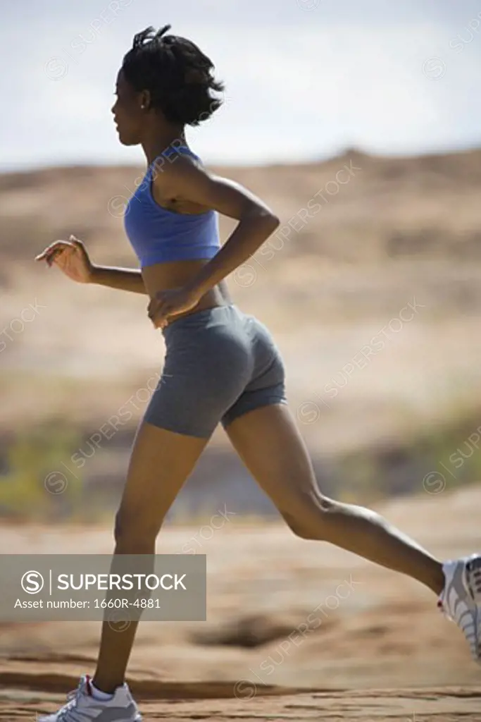 Profile of a young woman jogging