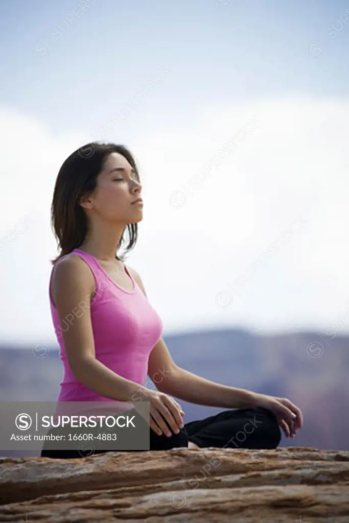 Profile of a young woman meditating