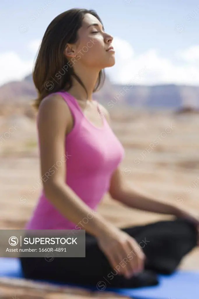 Profile of a young woman meditating