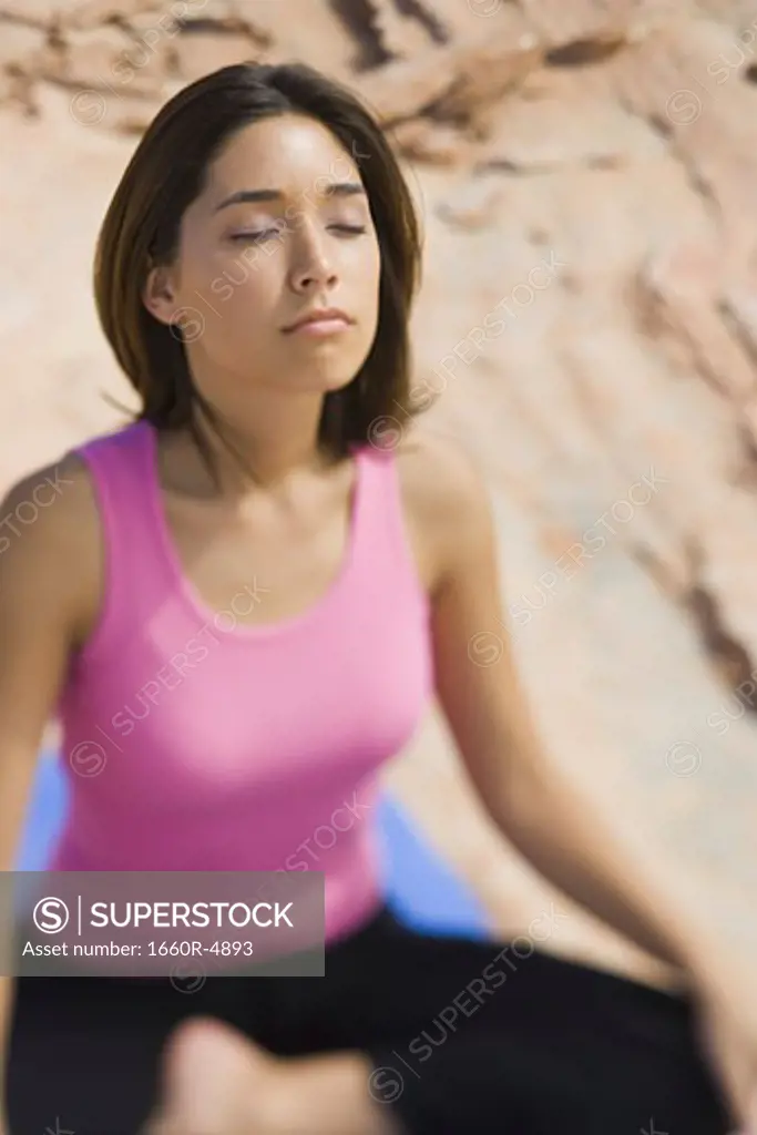 High angle view of a young woman meditating