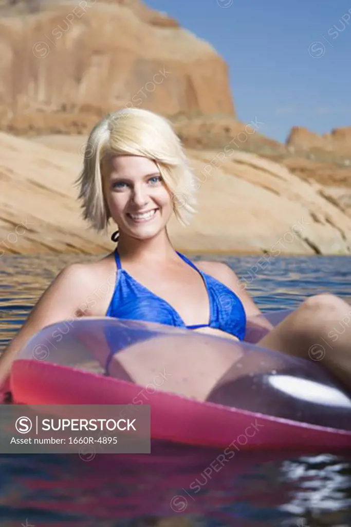 Portrait of a young woman sitting in an inflatable raft