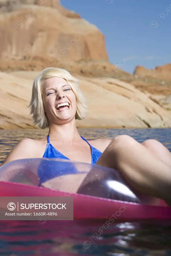 Young woman sitting in an inflatable raft