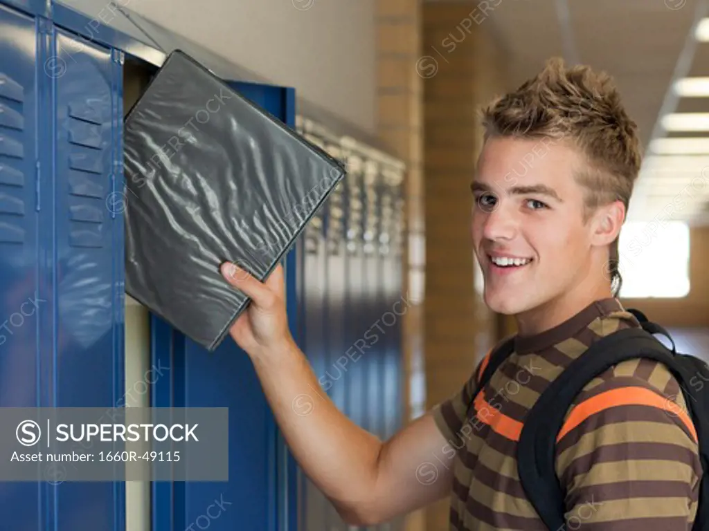 USA, Utah, Spanish Fork, Portrait of school boy (16-17) taking file from locker