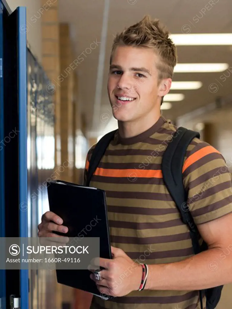 USA, Utah, Spanish Fork, Portrait of school boy (16-17) holding file in corridor