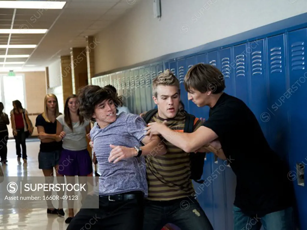 USA, Utah, Spanish Fork, Three boys (16-17) fighting in school corridor