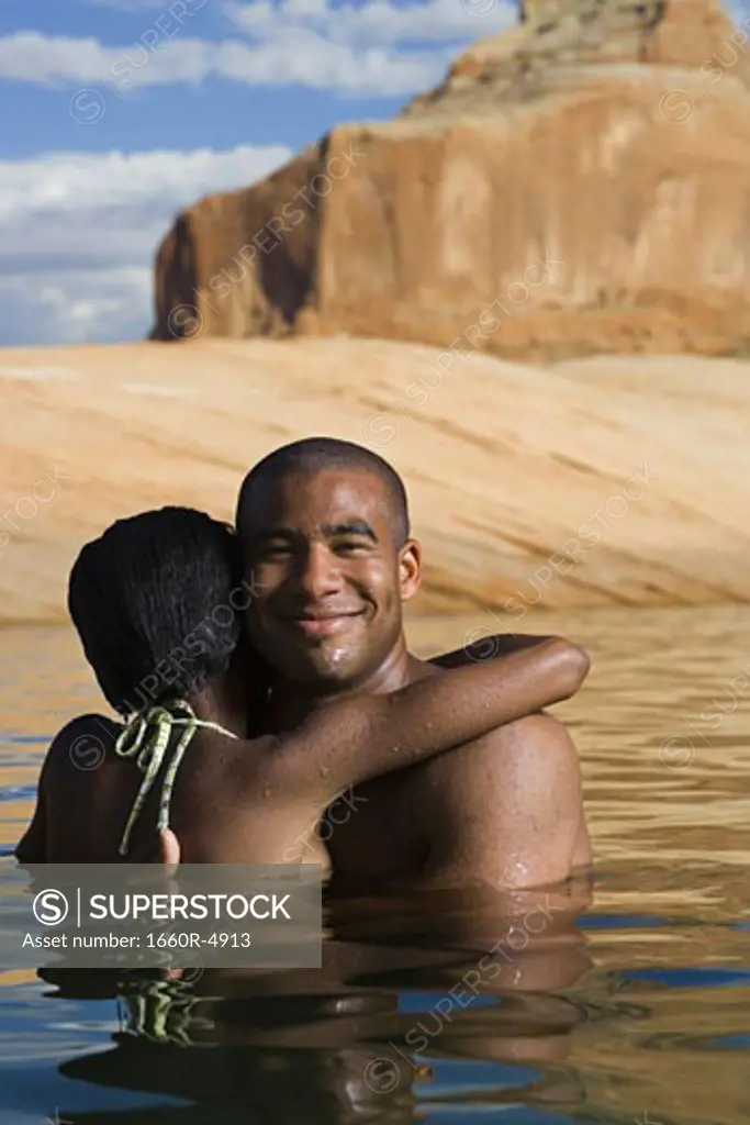 Young couple embracing in a lake