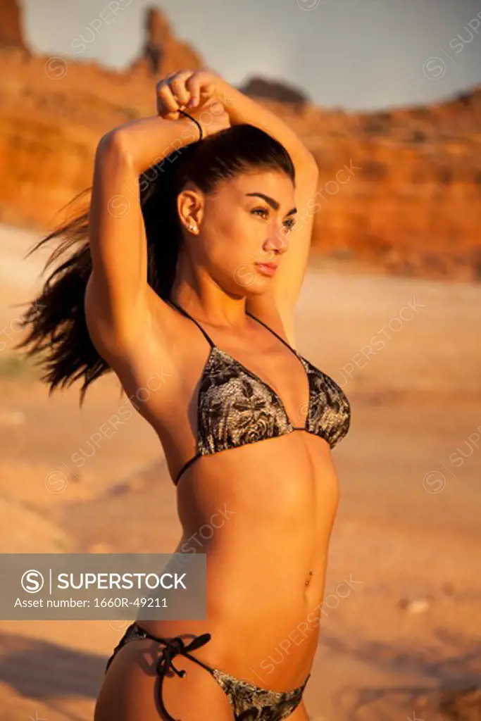 USA, Utah, Lake Powell, Young woman wearing bikini and looking away