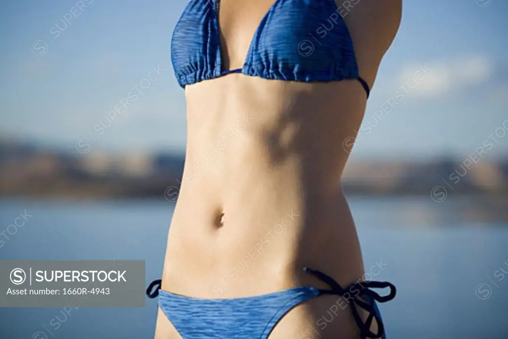 Mid section view of a young woman in a bikini