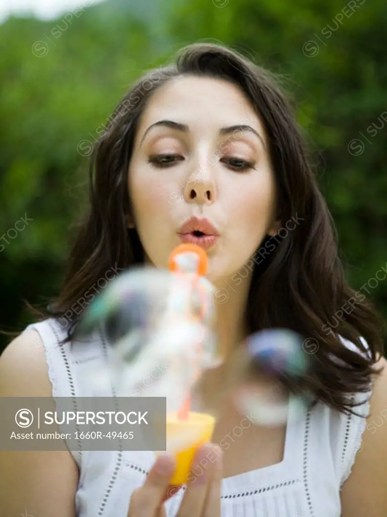 USA, Utah, Orem, Portrait of woman blowing bubbles