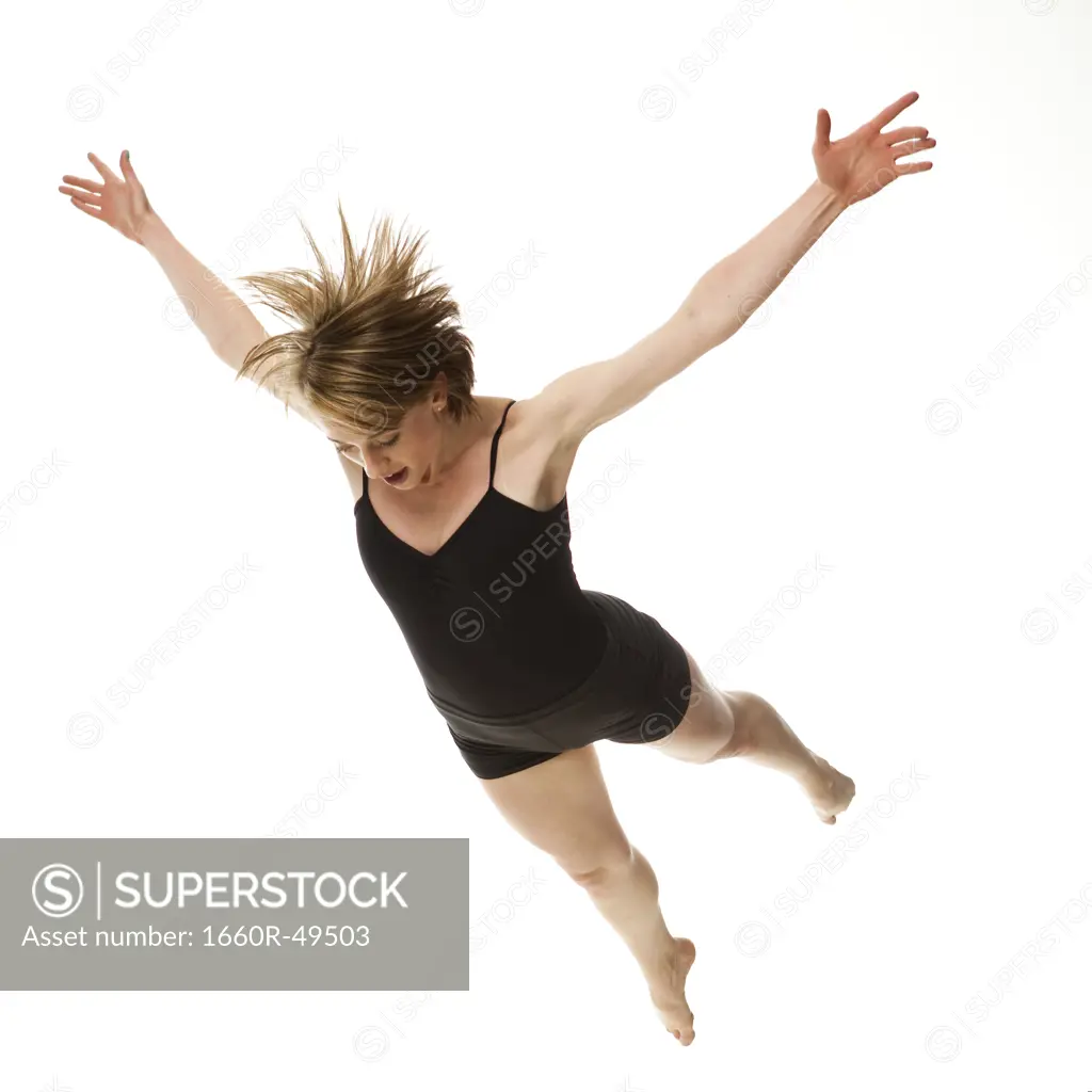 Woman falling against white background