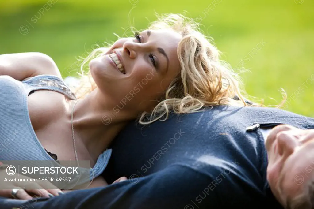 UK, London, Couple relaxing on grass