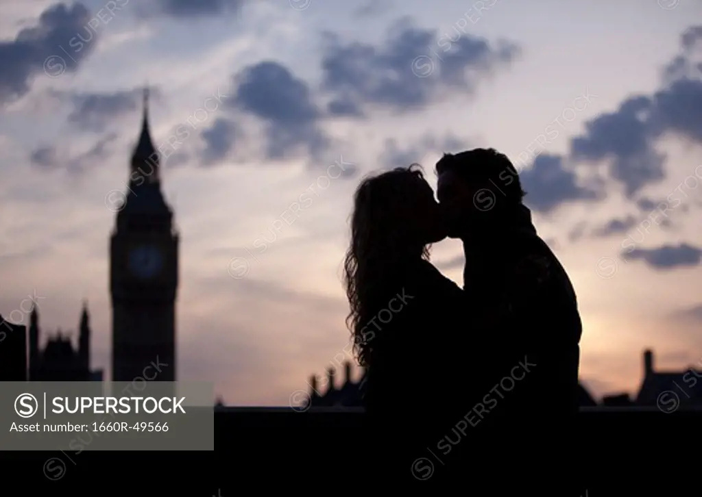 UK, London, Silhouette of couple kissing at sunset