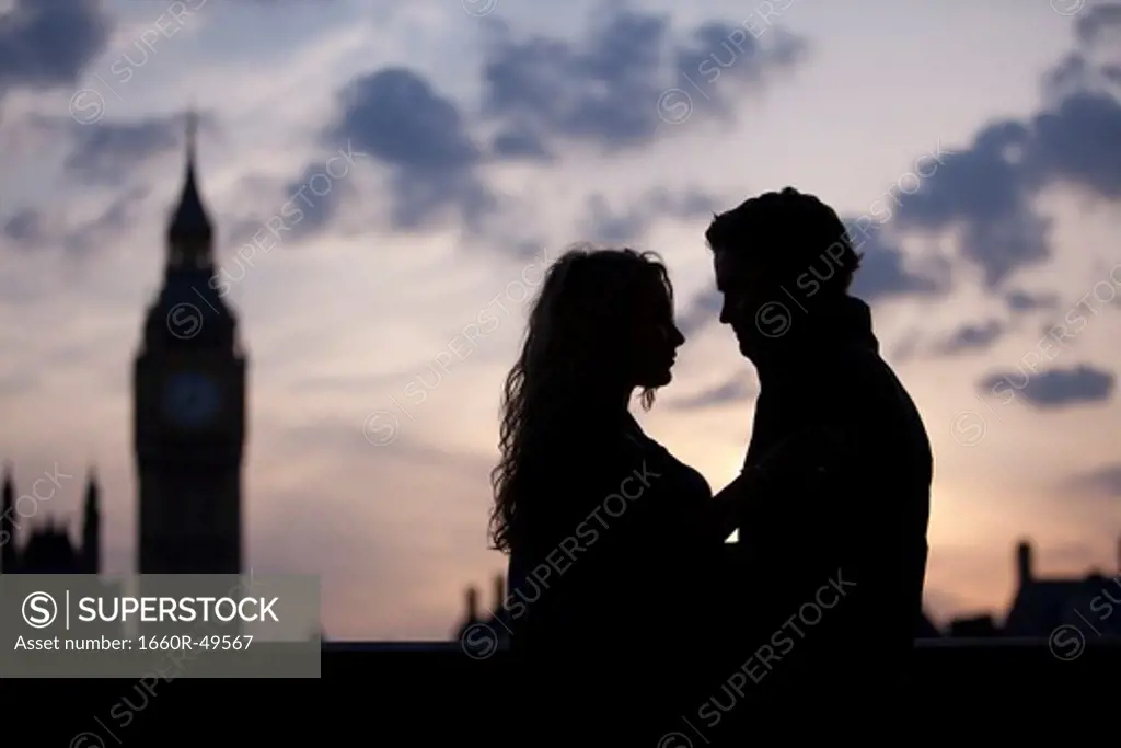 UK, London, Silhouette of couple embracing at sunset
