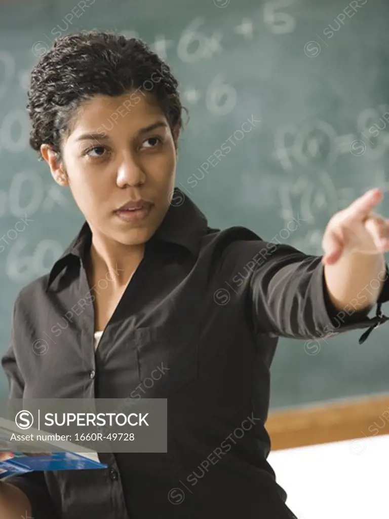 Young person  posing in front of chalkboard