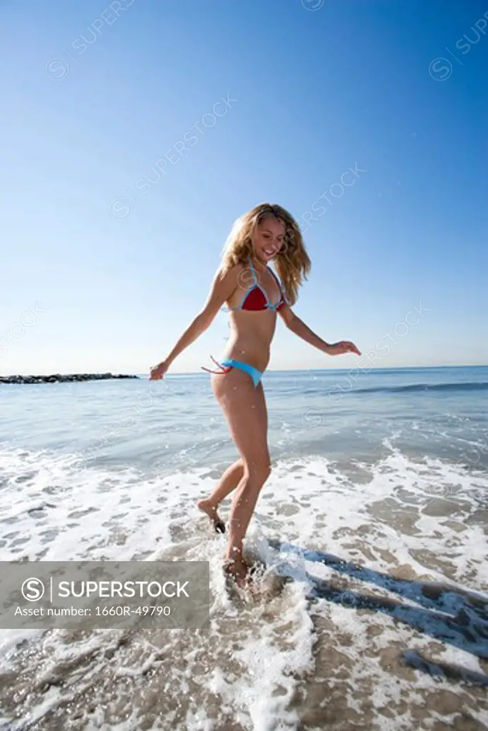 Woman running in shallow water