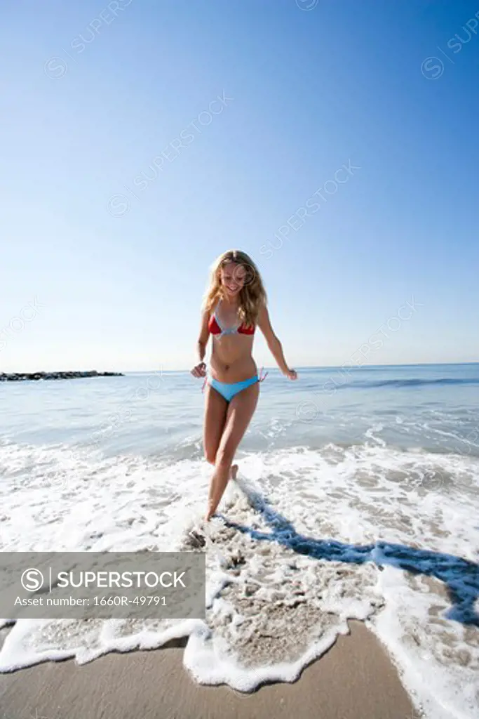 Woman running in shallow water