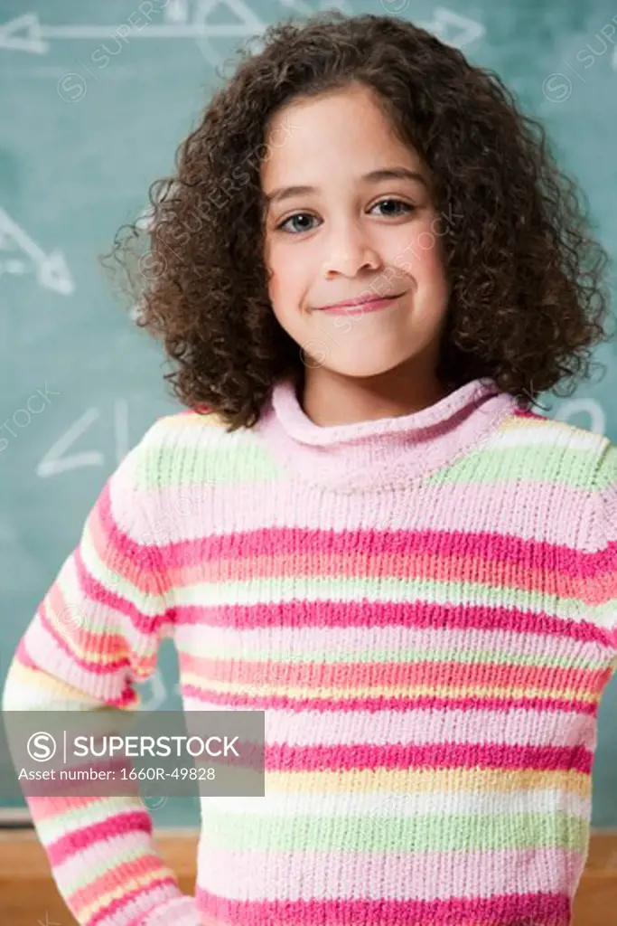 Girl posing in front of chalkboard