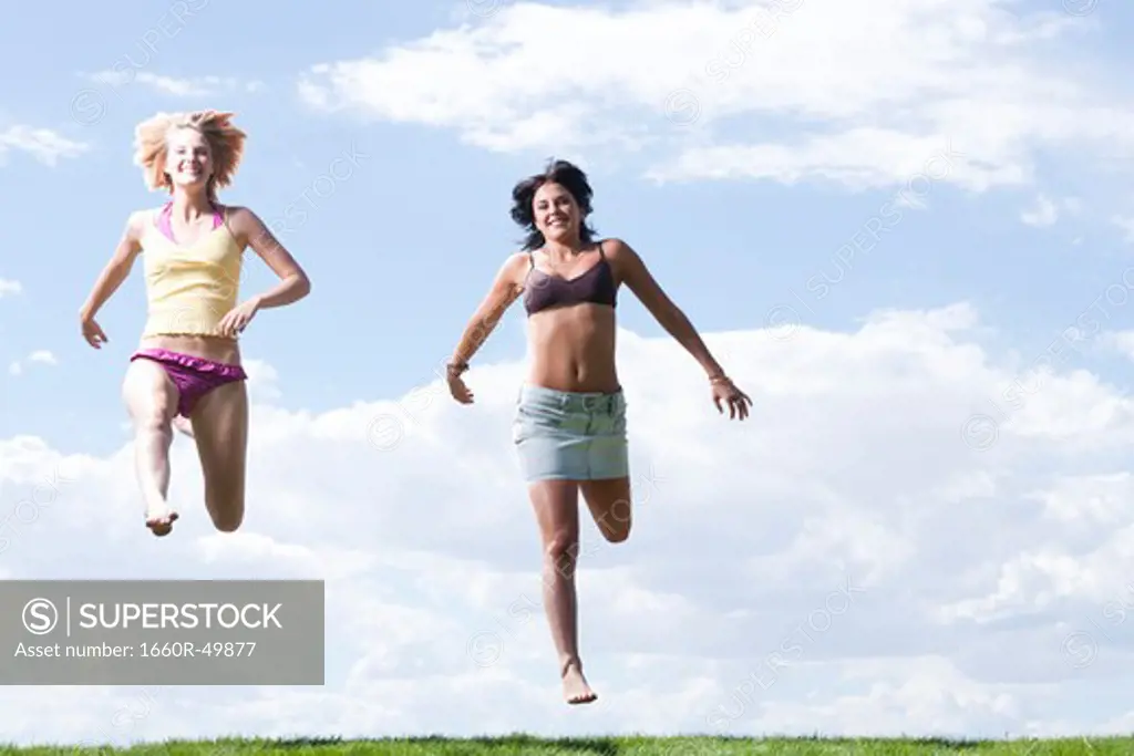 Two women leaping in the air