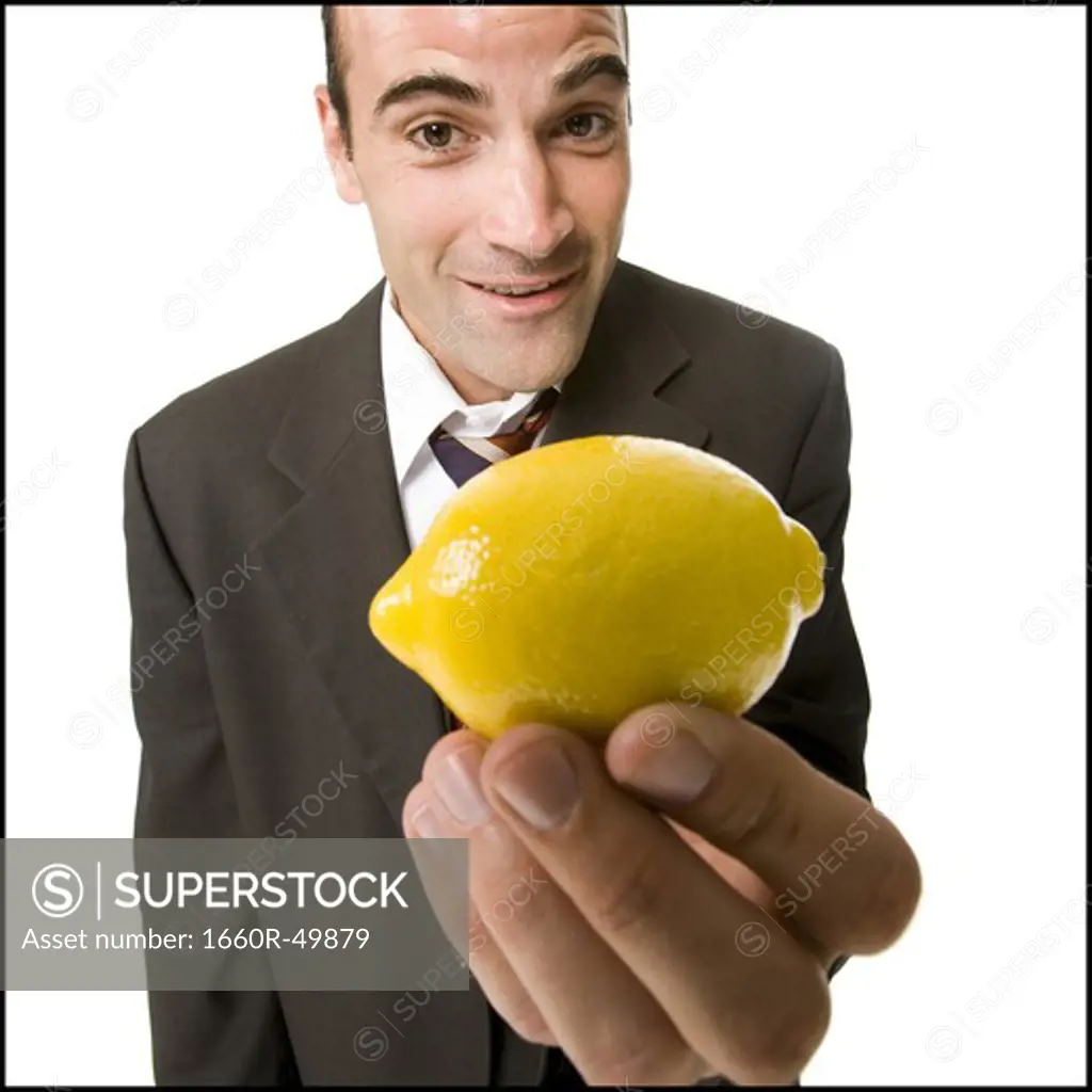 Businessman offering a lemon
