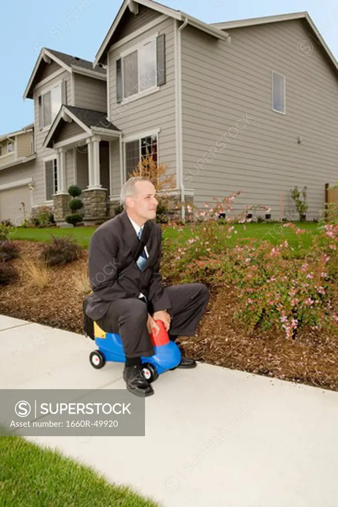 Business man on toy car