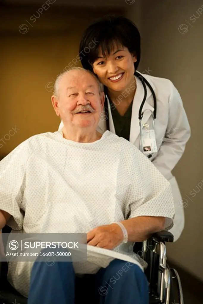 Female doctor with mature man in wheelchair
