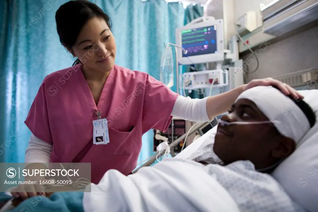 Nurse talking with boy in hospital bed
