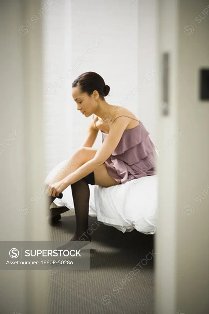 Woman putting on pantyhose